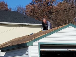 Joe Gorman replacing shingles on roof